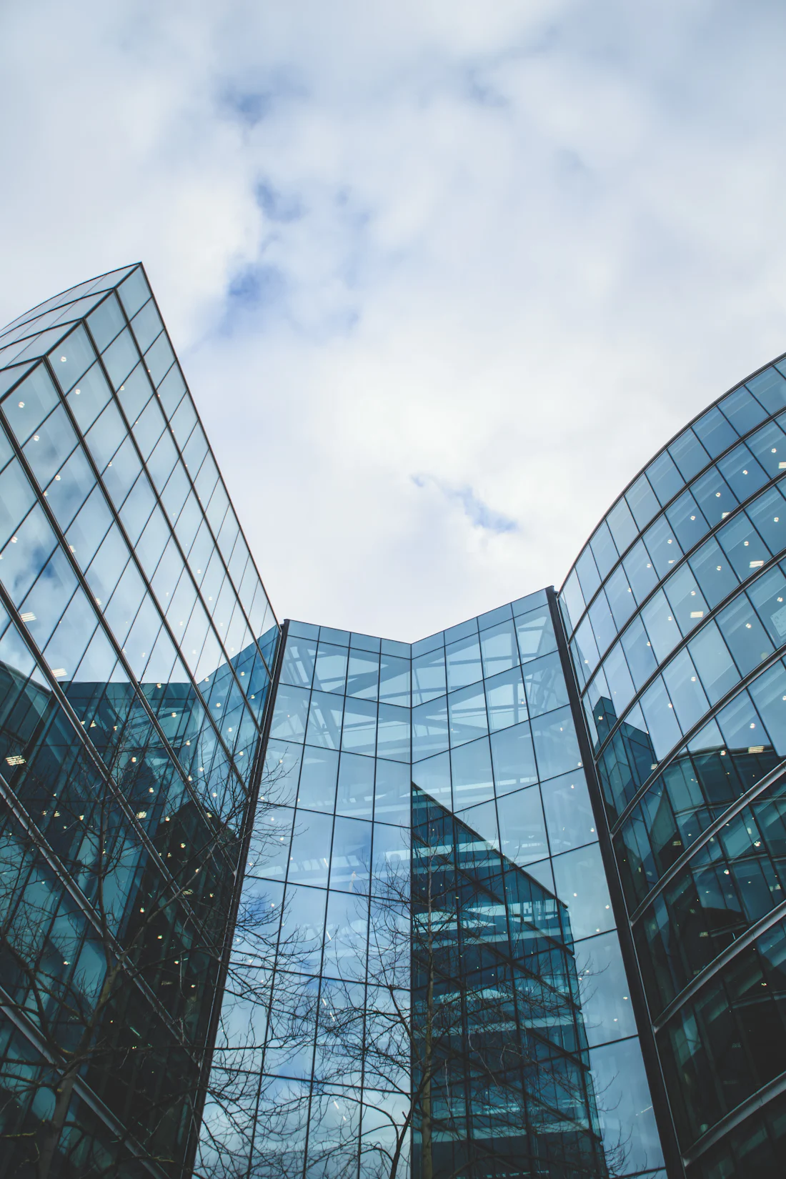 Glass towers rising, seen from below